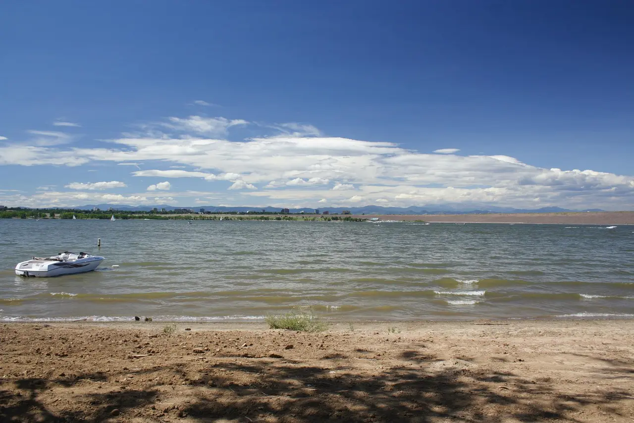 Cherry Creek Reservoir under a wide summer sky with a boat near the shoreline, Cherry Creek State Park, Aurora