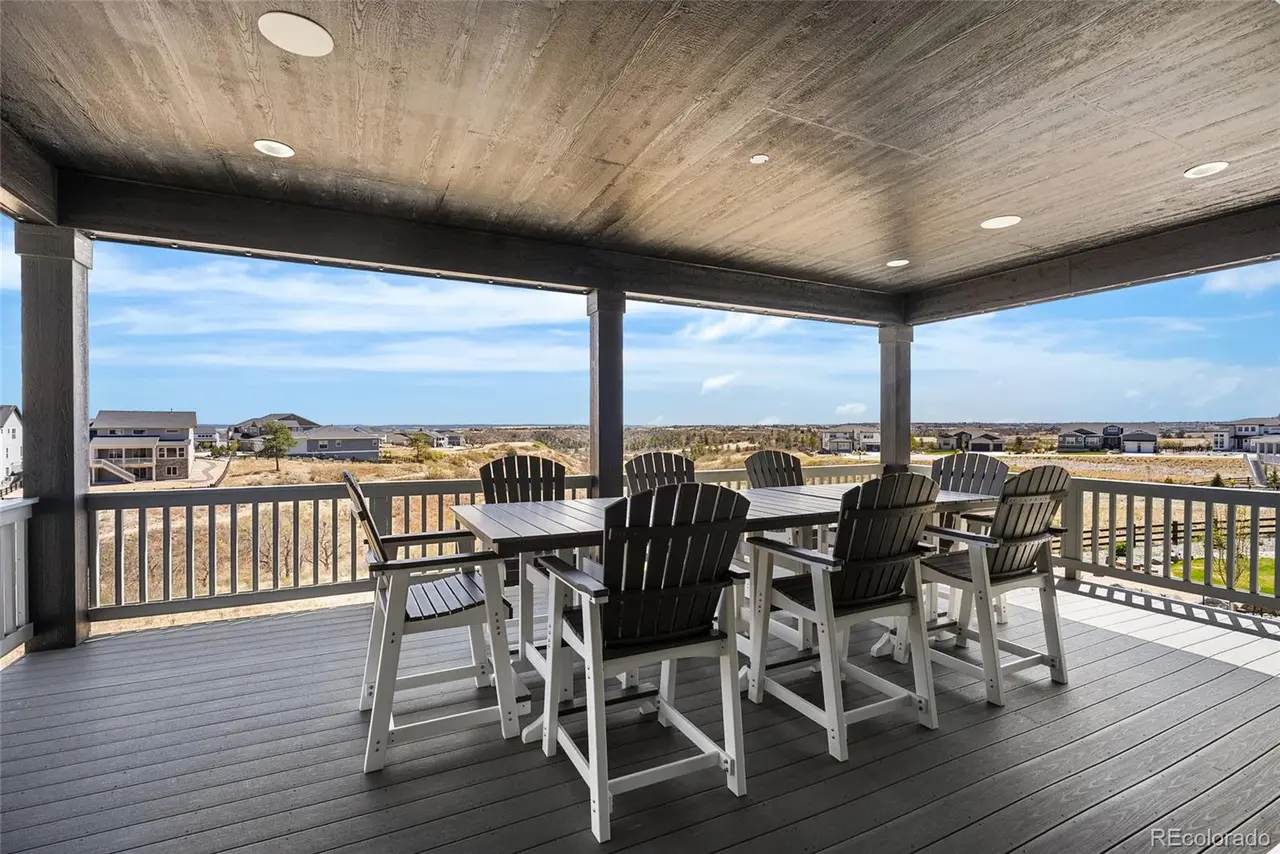 Covered deck with outdoor dining facing open canyon views in Castle Rock