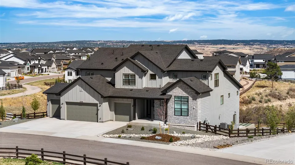 Aerial view of the home and surrounding canyon terrain