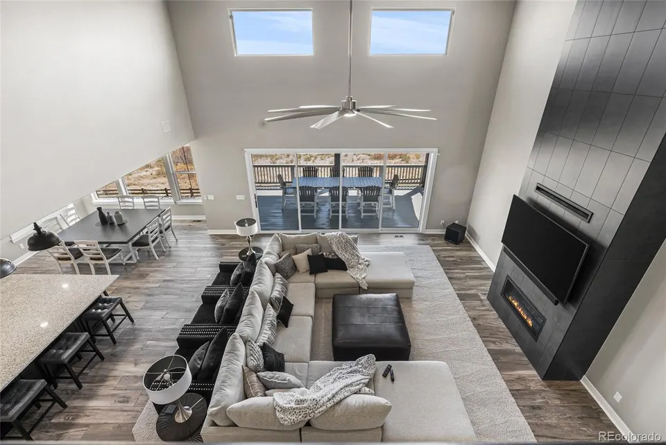 Living area with linear fireplace and sliding glass doors to the deck