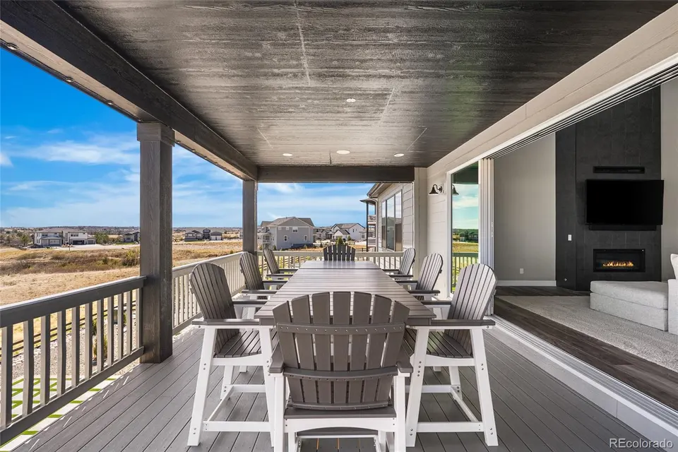 Covered deck with outdoor fireplace and seating