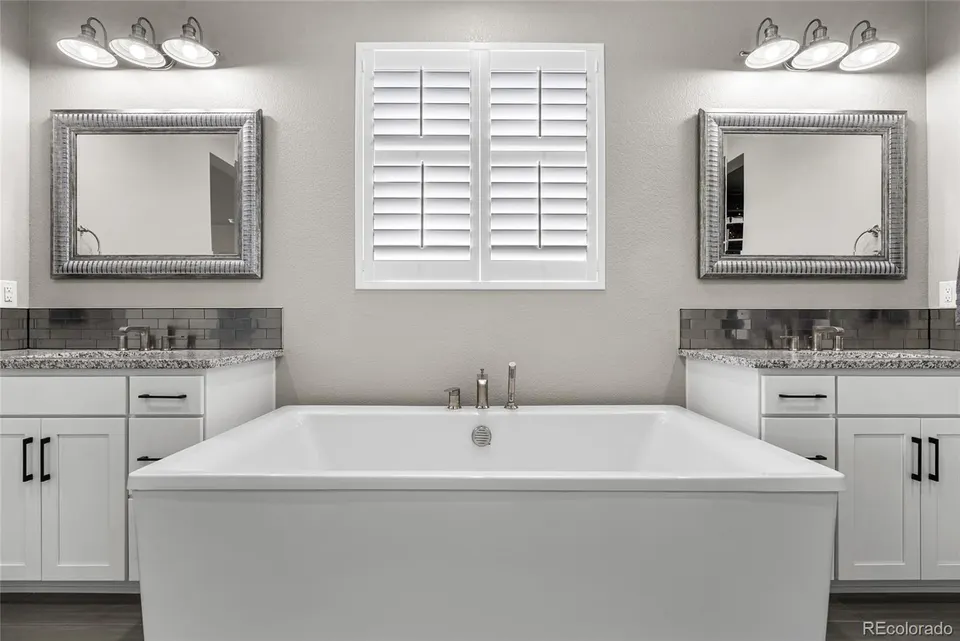 Primary bath with freestanding soaking tub and dual vanities