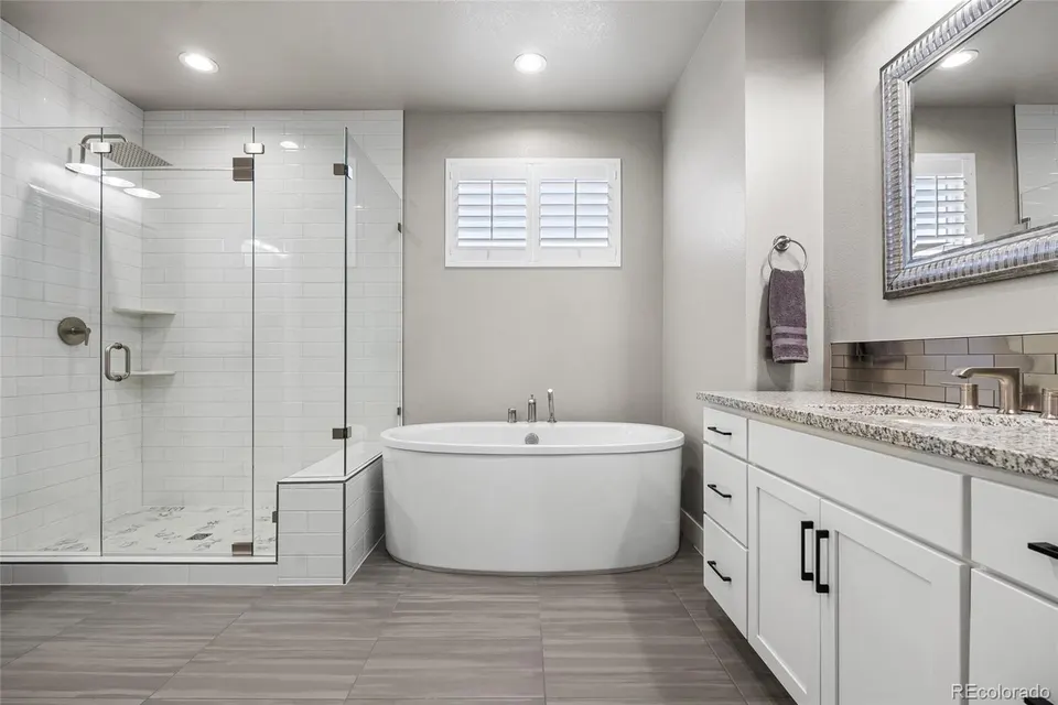 Secondary bath with glass shower and soaking tub
