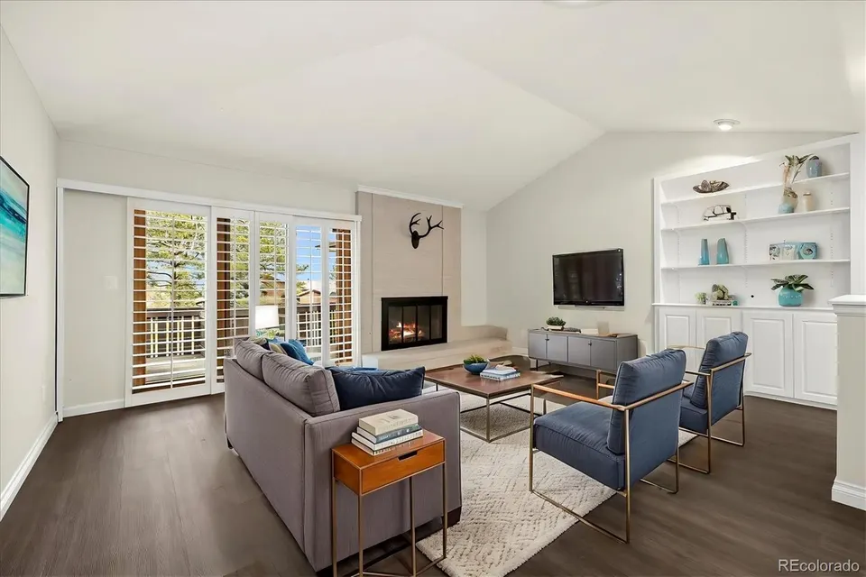 Vaulted living room with fireplace and built-ins at 6300 West Mansfield Avenue