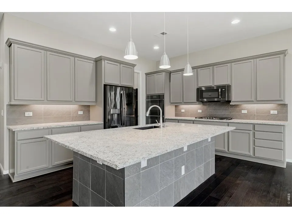 Kitchen island with granite counters and stainless appliances