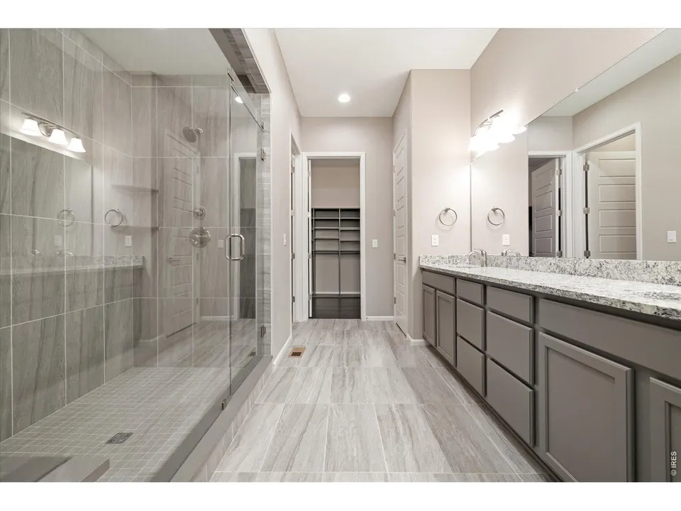 Primary bath with oversized glass shower and double vanity