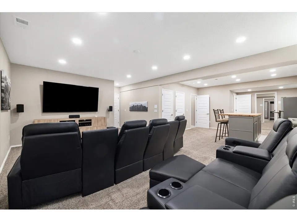 Basement home theater with tiered leather seating